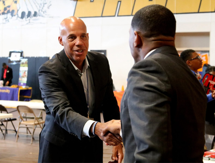 People at an event shaking hands