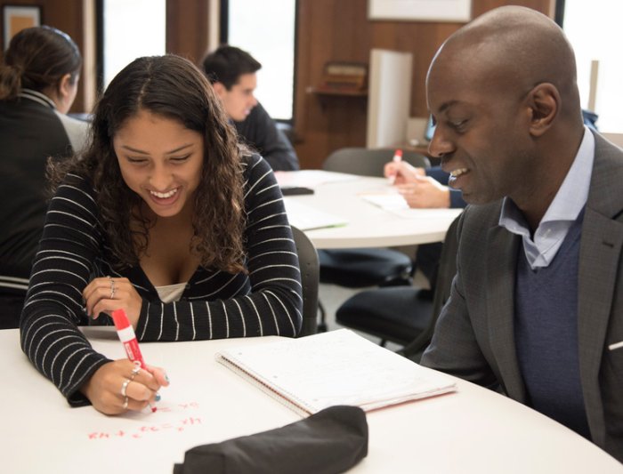 student and teacher at desk