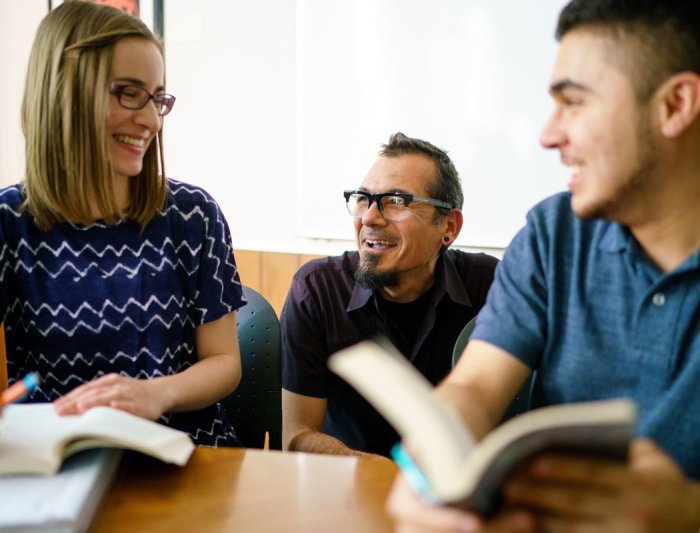 Students in class talking to a professor
