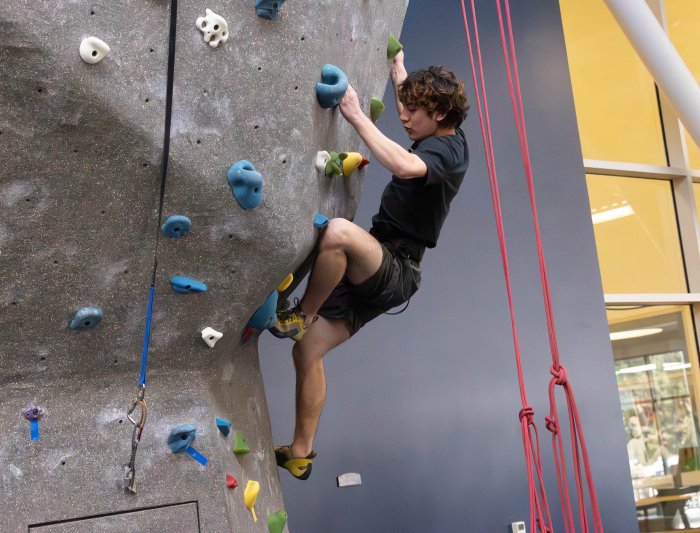 Matthe Menzi carefull places his foot on the hold at the climbing wall