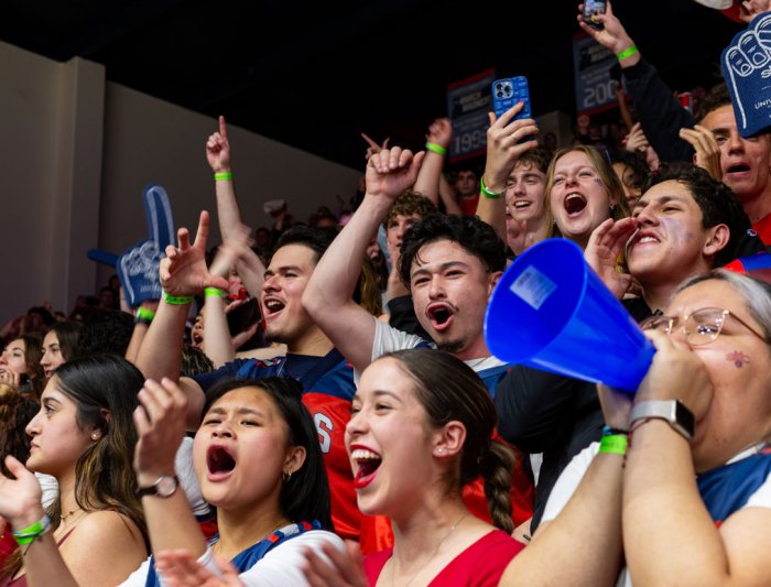 Students cheering at a basketball game
