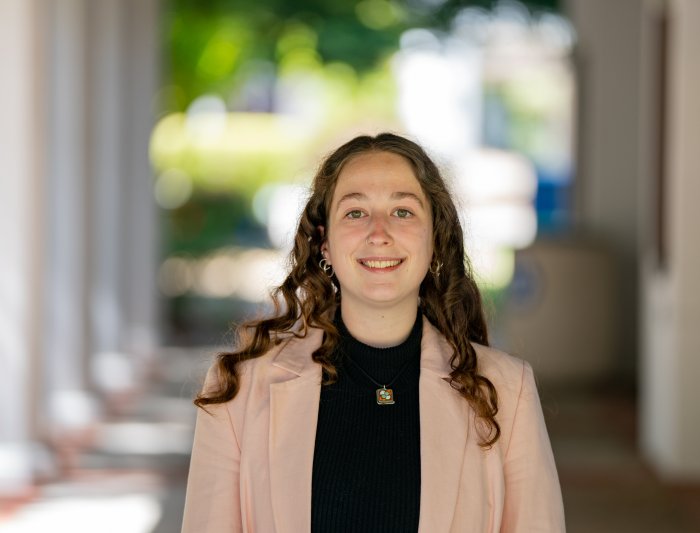 Headshot of woman standing in corridor