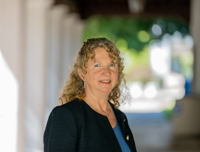 Headshot of woman standing in corridor