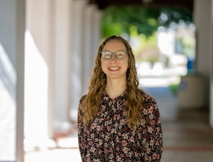 Headshot of woman standing in corridor
