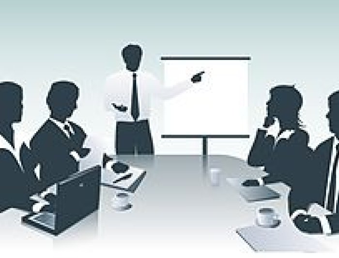 presentation icon where a man is stand and pointing to the board and four other people looking at him