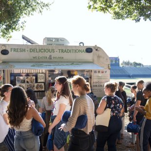 Students gathered outside of a food truck