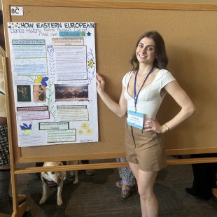 Student in front of a conference poster presentation