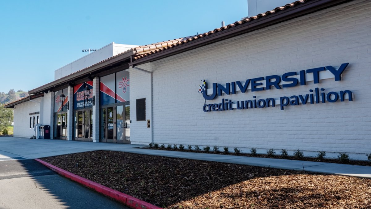 The front of the SMC gym with a sign for the University Credit Union Pavilion