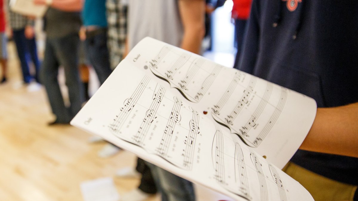 A student offscreen reading sheet music