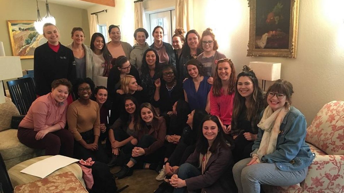 Students in a group with a famous speaker