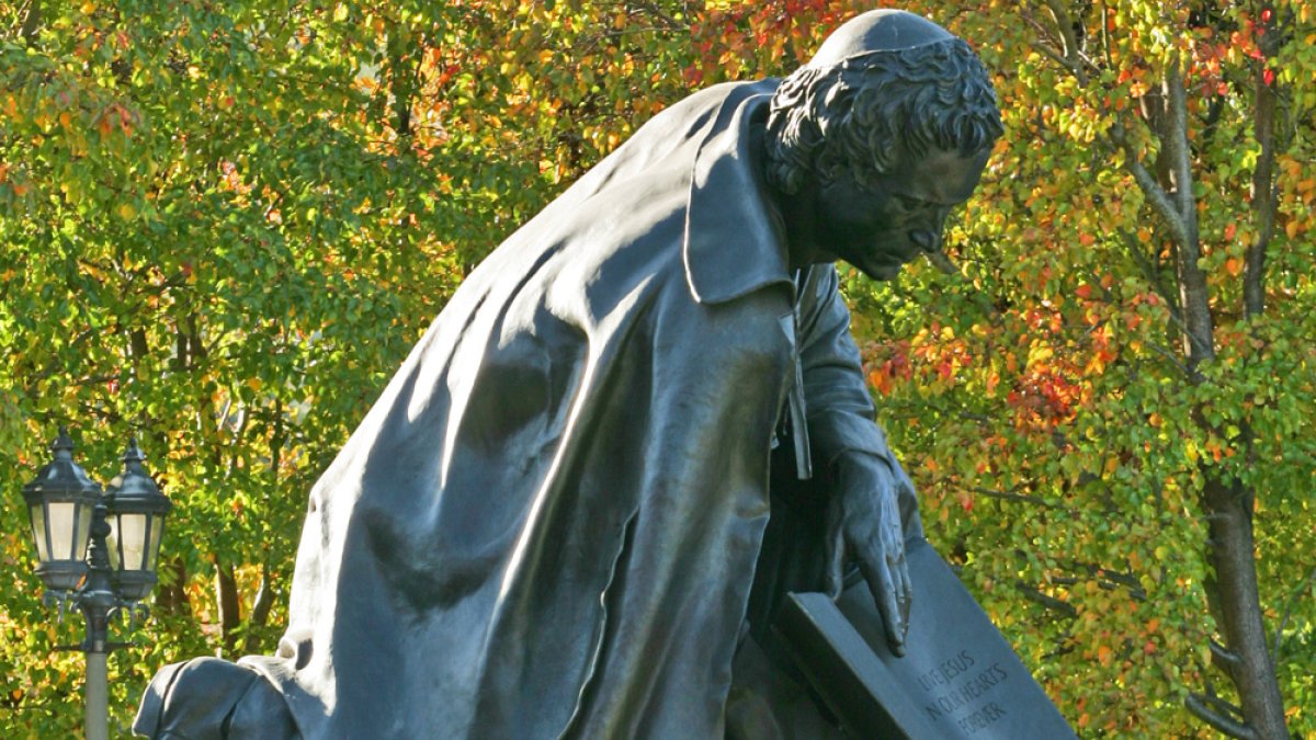 statue with foliage in the background