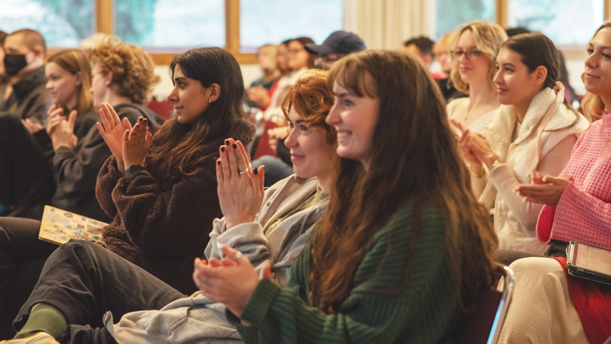 Students in Clayes clapping at a staged reading of Angels in America