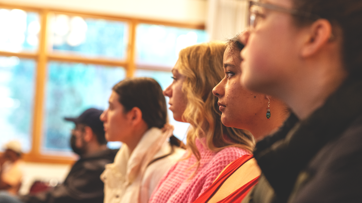 Students in Claeys Lounge looking toward the screen