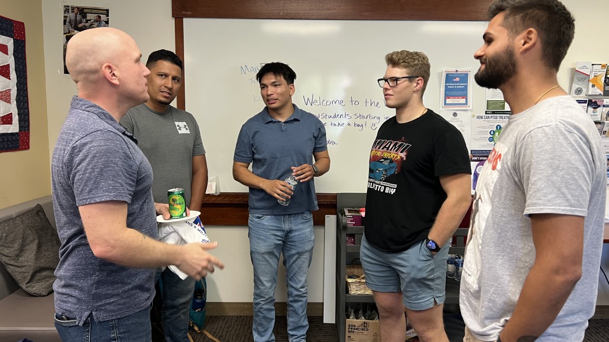 Picture of 5 people standing inside the Veteran Resource Room