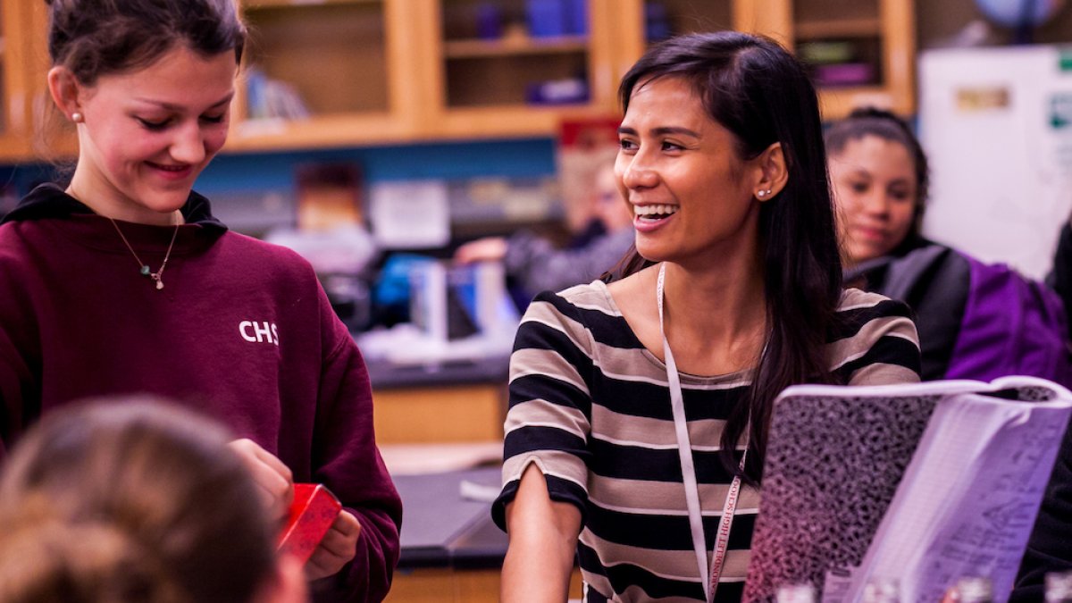 SMC female teacher with students in a science classroom