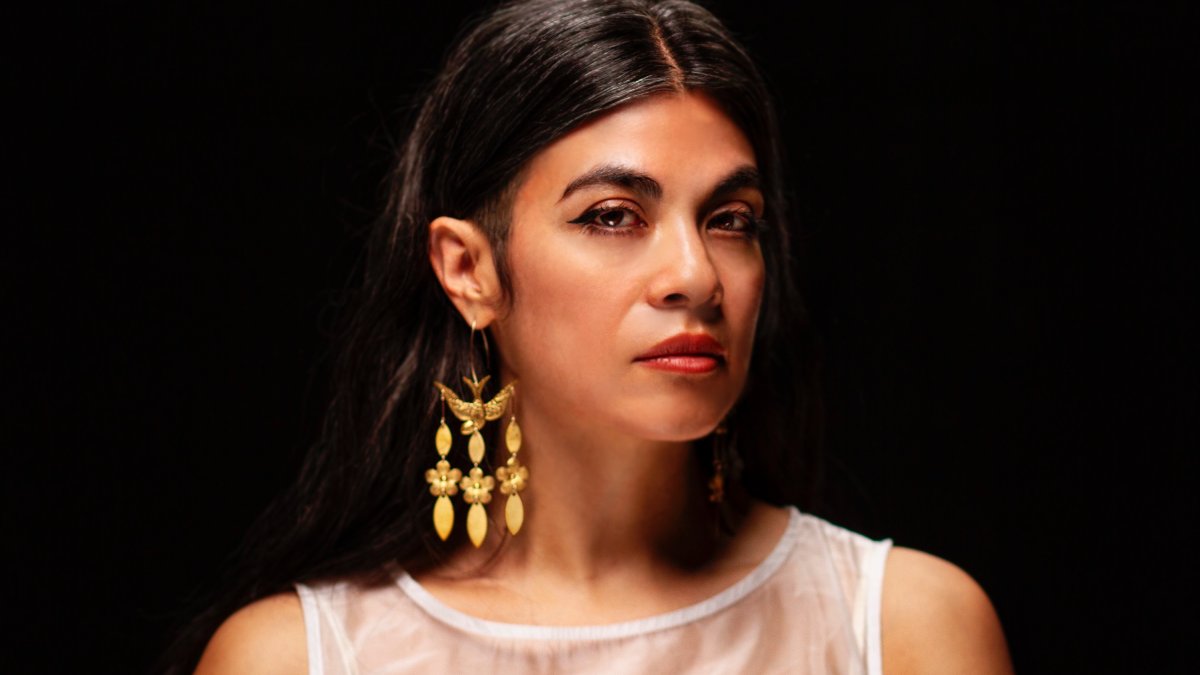 headshot of novelist and faculty member ingrid rojas contreras on a black background