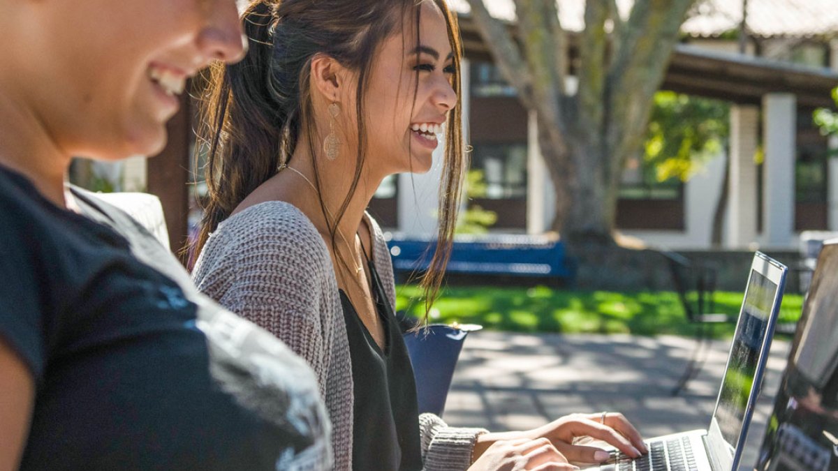 Students laughing while in a writing studies class