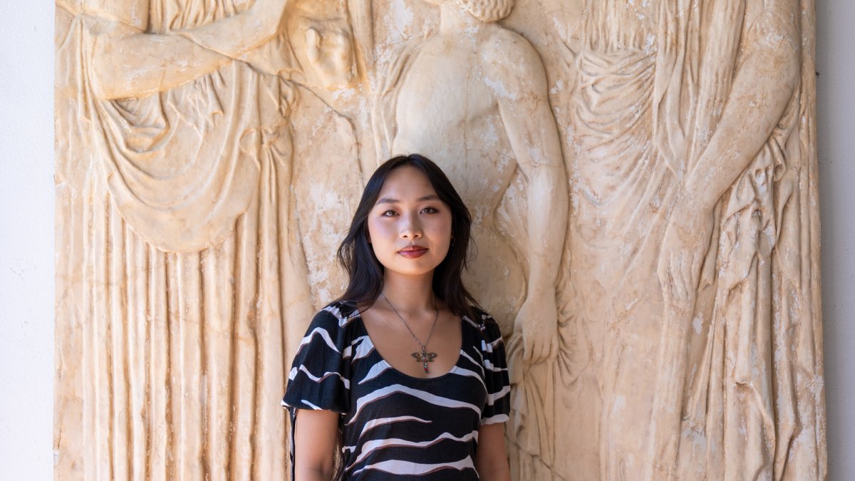 Isabelle Ly posing in from classical artwork on campus