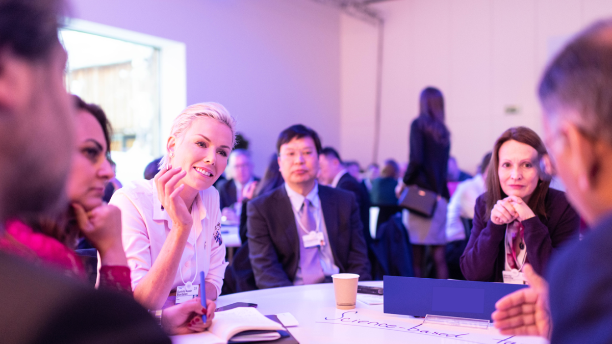 people sitting around table and talking